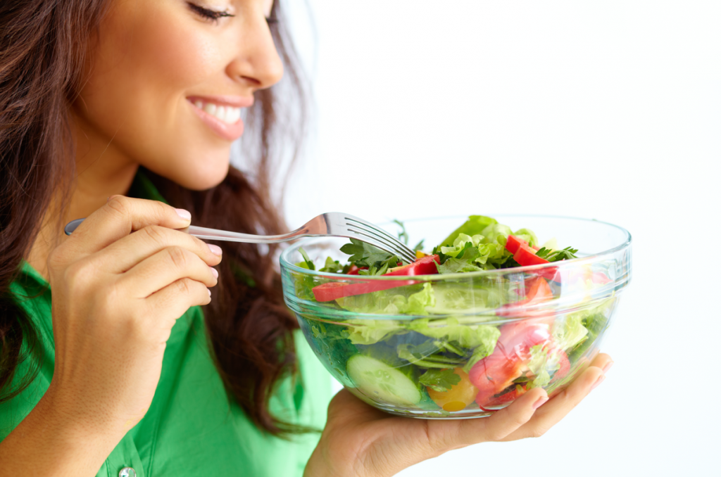 fit woman eating salad