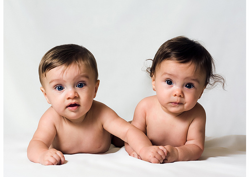 Two cute twin babies, a girl 